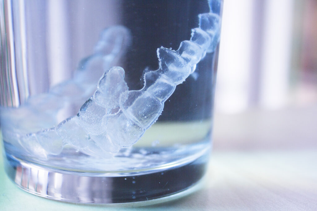 Invisible dental orthodontic submerged in water for cleaning