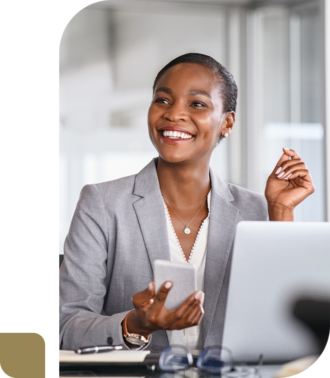 smiling business woman sitting at desk looking up at a client