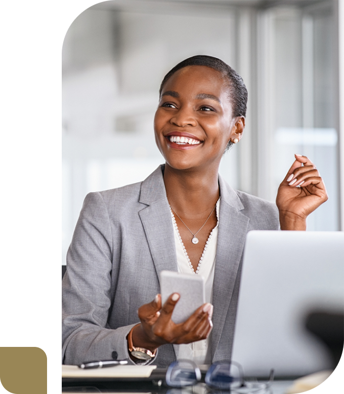 smiling business woman sitting at desk looking up at a client