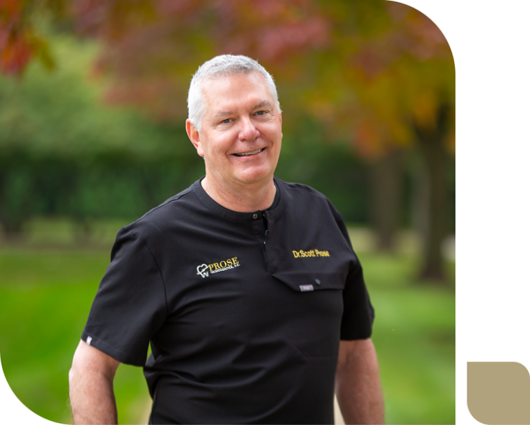 Outstanding orthodontist in St. Charles, IL, Dr. Scott Prose smiling in his Prose Orthodontics scrubs