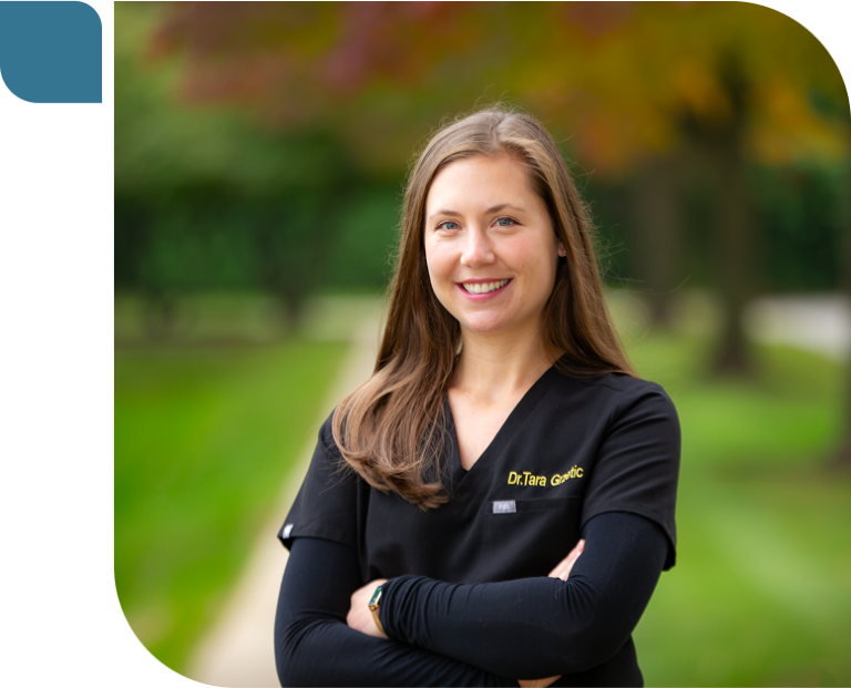 Expert St. Charles orthodontist Dr. Tara Grzetic smiling in her Prose Orthodontics scrubs