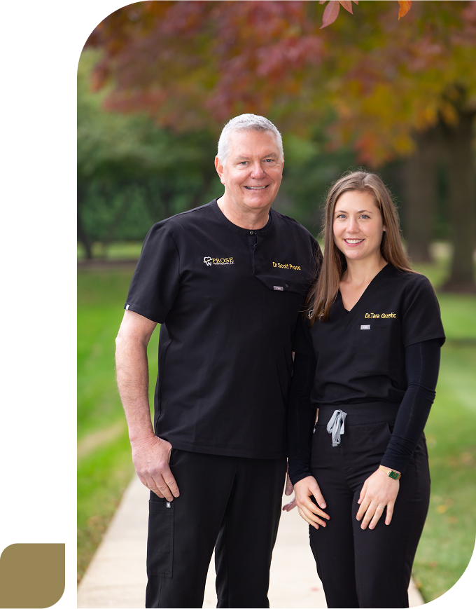Orthodontists Drs. Grzetic and Prose side by side in their Prose scrubs in the park